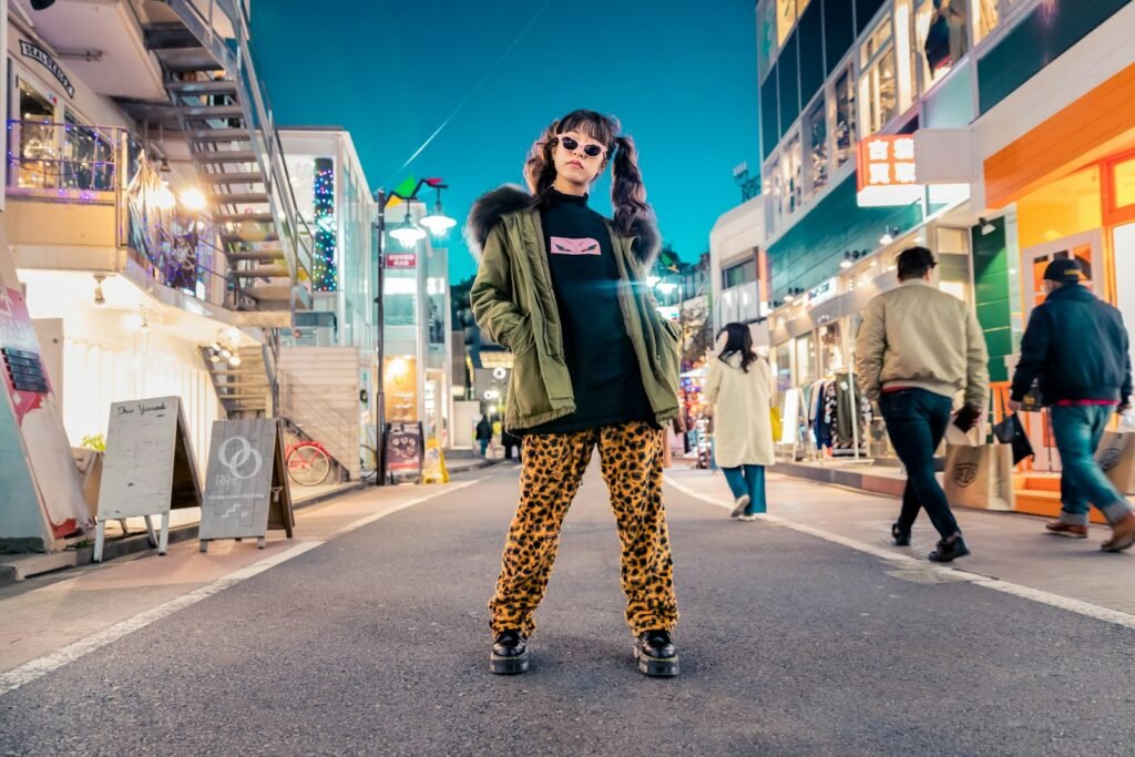 woman in green jacket stands and pose on street