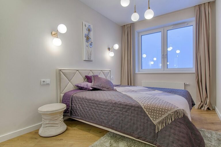 Stylish modern bedroom with purple accents and elegant lighting.