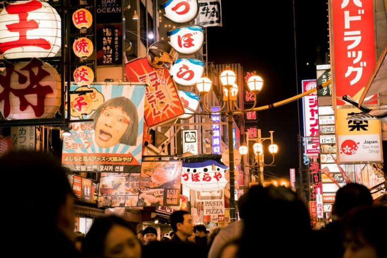 Explore the bustling nightlife of Osaka's Dotonbori street with vivid neon lights and bustling crowds.